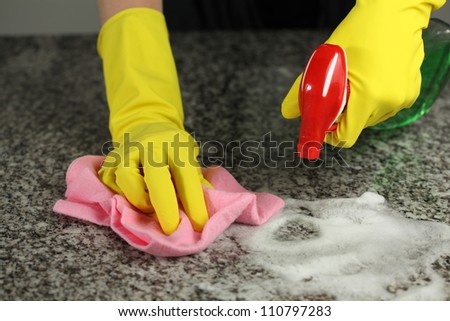 Cleaning A Counter Top With A Special Spray