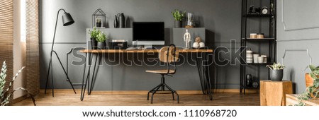 Open space living room interior with mockup computer, fresh plants and decoration placed on a home office desk