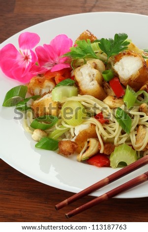 Plate with colorful chinese meal: salad with fish