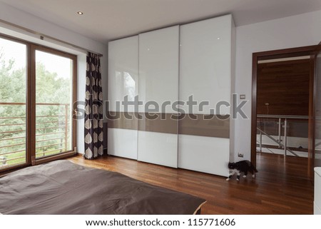 Contemporary Bedroom With Balcony And Huge Wardrobe