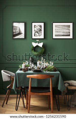 Bottle green dining room with table set for Christmas dinner