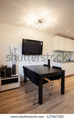 Stylish flat - Dining room with a black table and TV