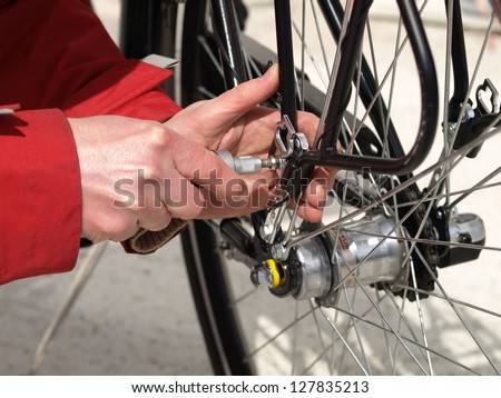 Serviceman repairing a bicycle tire with tools