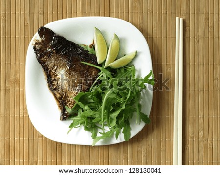 Fried fillet of salmon with rocket salad leaves