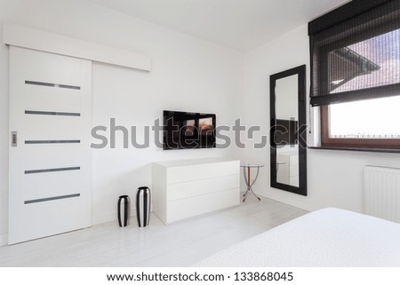 Vibrant cottage - white commode and black tv in bedroom