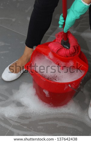 Detailed mopping dirty floor tiles by housekeeping  service