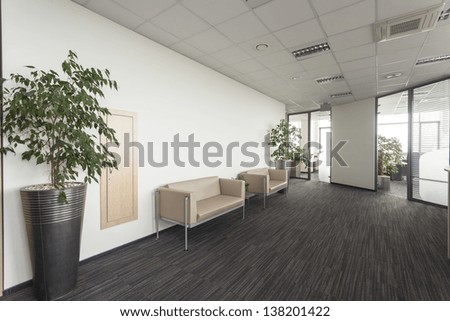 Interior of a modern office corridor with two sofa Interior of a modern office corridor with two sofa