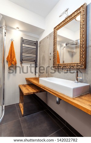 Interior of a new luxury bathroom with golden mirror