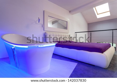Interior of a purple bedroom, bed and bath