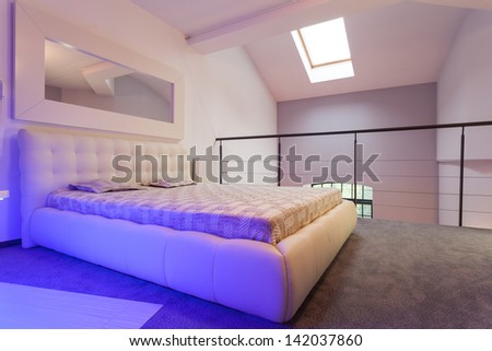 Huge white bed standing on the balcony, loft