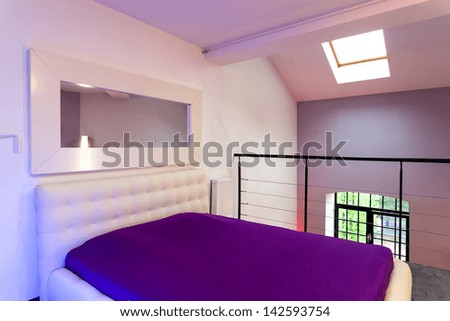 White and violet bed in the loft