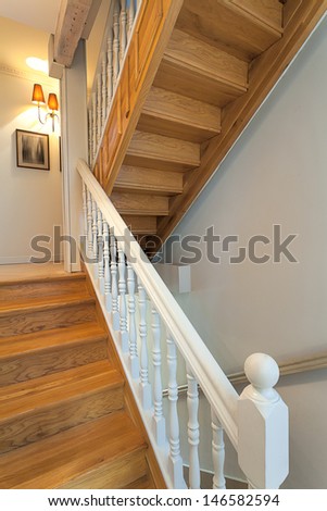 Vintage mansion - brown wooden stairs with a white barrier