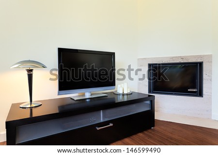Bright Space - A Living Room Corner With A Tv Set And A Fireplace