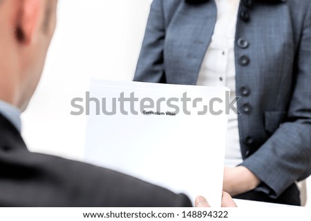 An interview and manager holding curriculum vitae