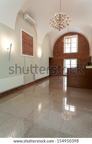 Gothic interior with brick wall and elegant chandelier