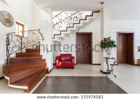 Classy house - Corridor with elegant stairs and armchair