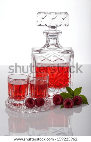Homemade liquor made with raspberries in carafe