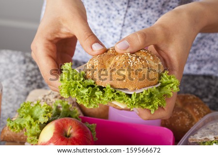 Fresh crispy bun with cheese and lettuce for a lunch box
