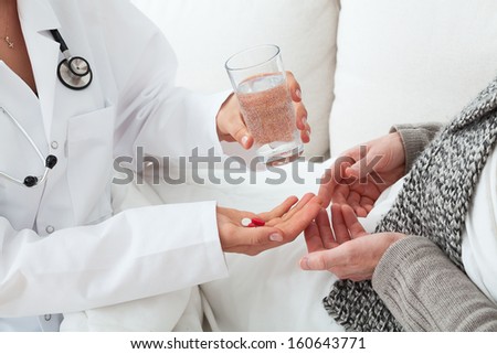 House call, doctor and a patient with flu