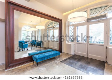 Interior Of A Hall With Mirror And Turquoise Sofa