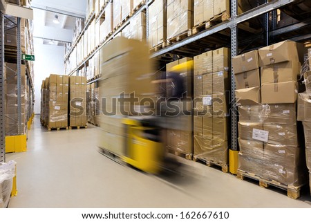 Fork Lift Operator Preparing Products For Shipment
