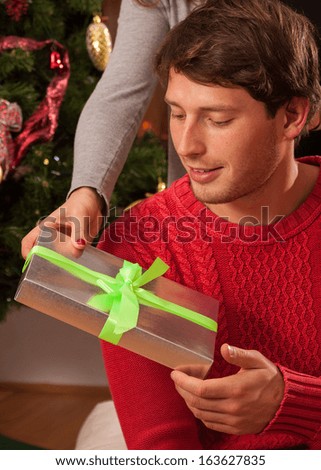 Girl giving a christmas present to her boyfriend