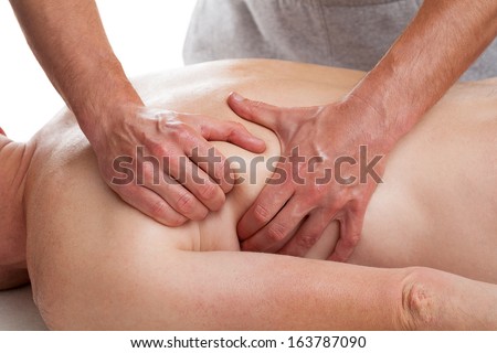 Masseur  applying advanced massage techniques in order to relax patient\'s muscles.
