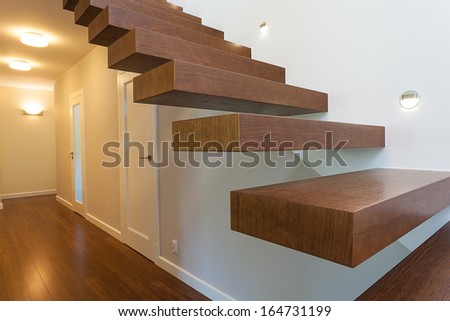 Bright space - brown wooden steps in a modern apartment