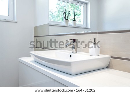 Bright space - a silver tap in a white bathroom
