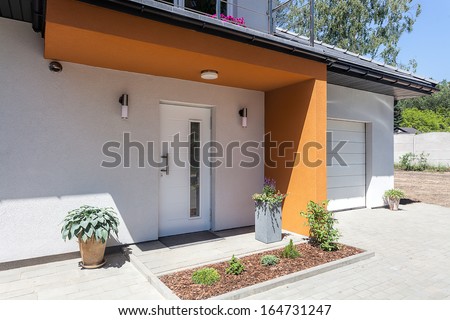 Bright space - a front door and a garage of a modern villa