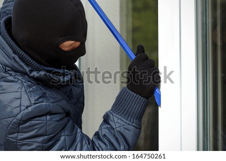 Housebreaker trying to open the window with crowbar