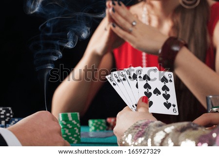 Poker game with drinks and cigarettes in casino