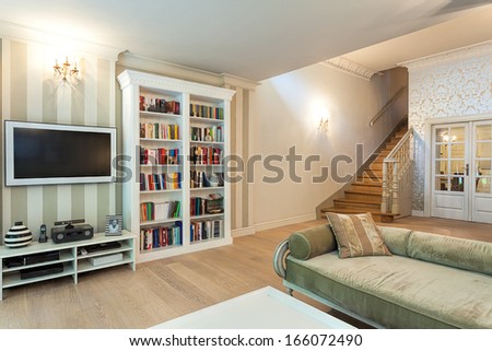 Vintage mansion - a striped wall with a tv set and a white bookshelf