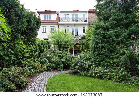 Vintage mansion - a garden with a path surrounded by plants
