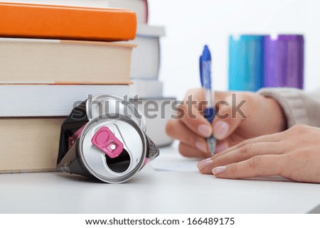Student learning with energy drinks before an exams