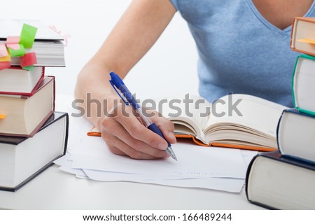 Woman with huge heap of books during learning