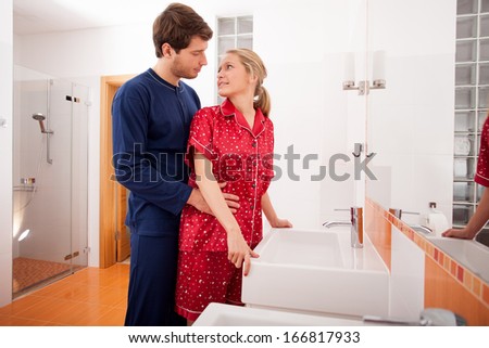 Couple in pajamas in the bathroom before going to sleep