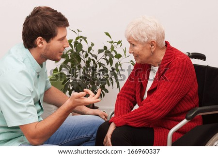 Nurse keeping company to disabled elderly lonely person