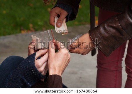 Close up of young person selling drugs to youth