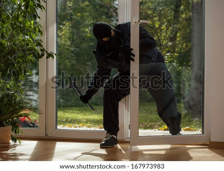 Burglar entering to house trough balcony window