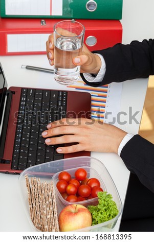 Manager sitting at desk with healthy meal