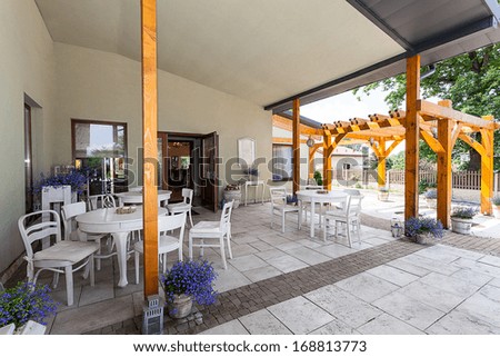 Mediterranean interior - a spacious veranda with white furniture