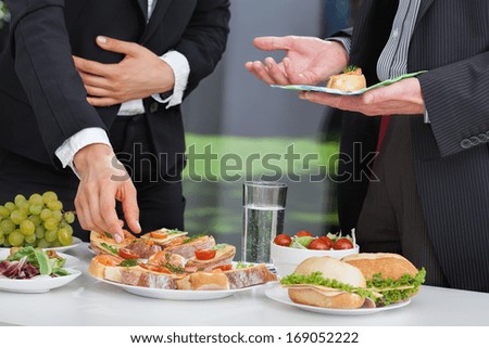 Business People Discussing At The Lunch Buffet