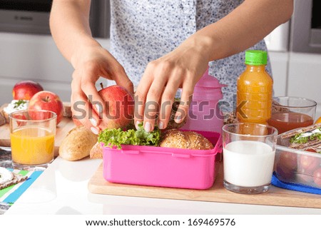 Young Woman Making School Lunch In The Morning