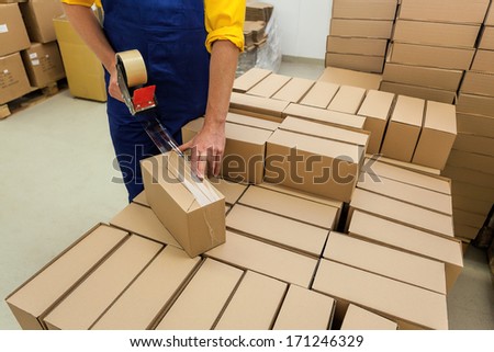 Warehouse worker packaging product for a customer Warehouse worker packaging product for a customer
