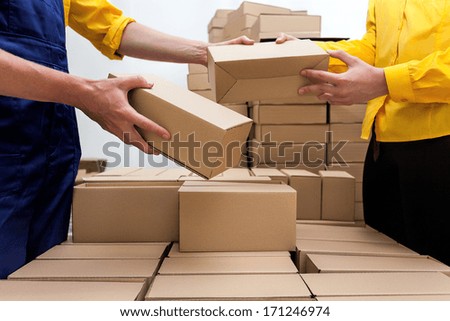 Workers in parcel delivery company preparing a deliver