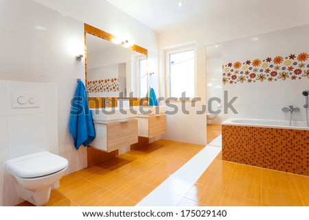 Modern Orange Bathroom With Two Sinks And Big Mirror