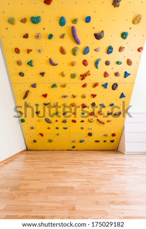 Yellow climbing wall in new kids room