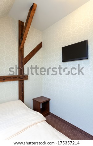 Warm modern classic hotel bedroom with tv and bedside cabinet