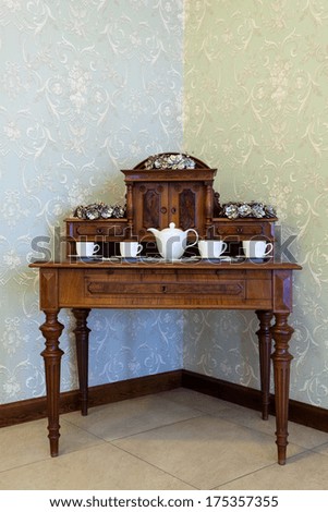 Beautiful brown figured old-fashioned dresser in the corner of stylish room